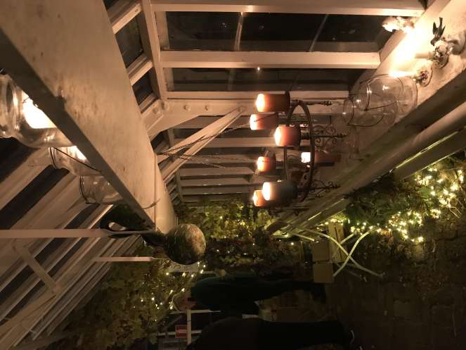 a garden shed lighted with hanging candles